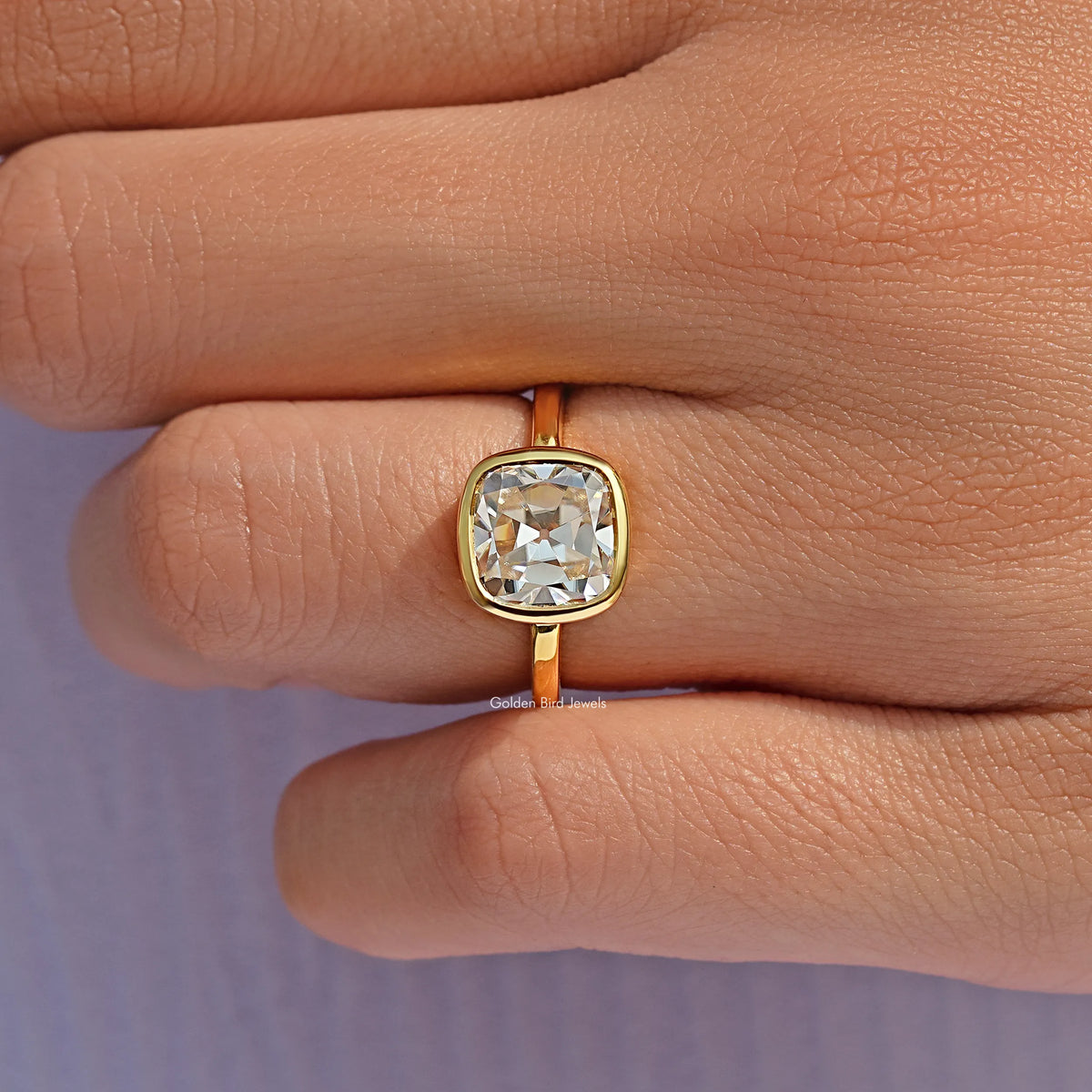 Square cushion moissanite in gold bezel solitaire ring, side view