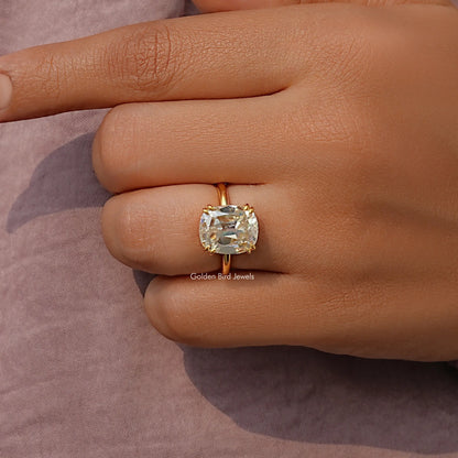 Gold-tone elongated cushion-cut solitaire ring with prong-set moissanite stone