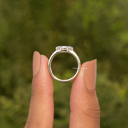Gold moissanite ring with prongs and clear center stone, top view