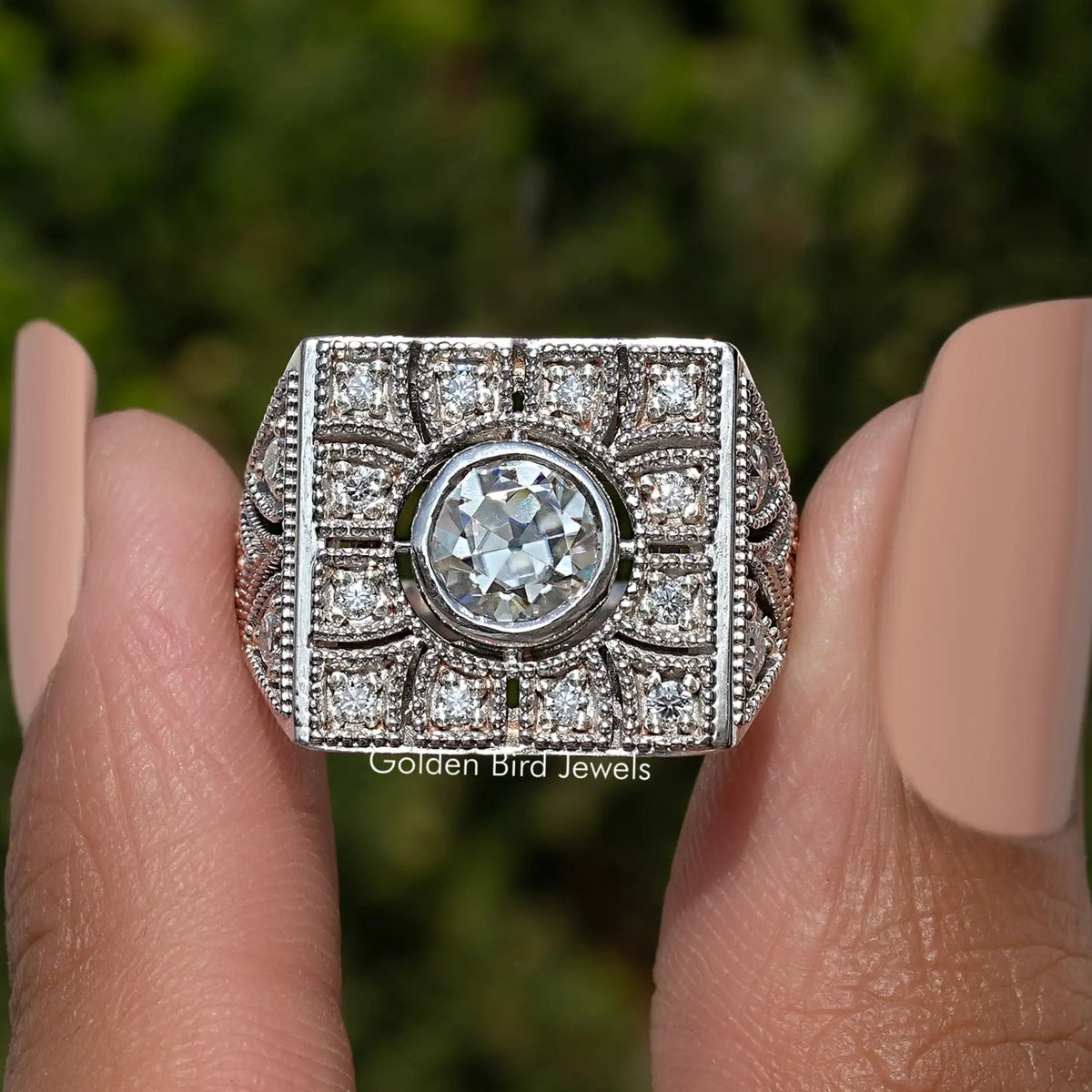 Art deco square ring featuring large round moissanite center and halo stones