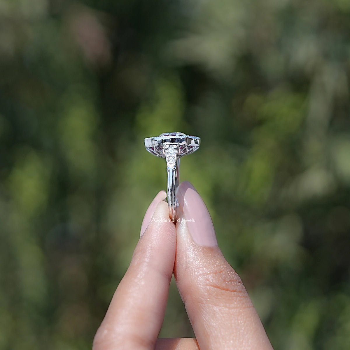 Round moissanite halo ring with prong-set center stone on split band