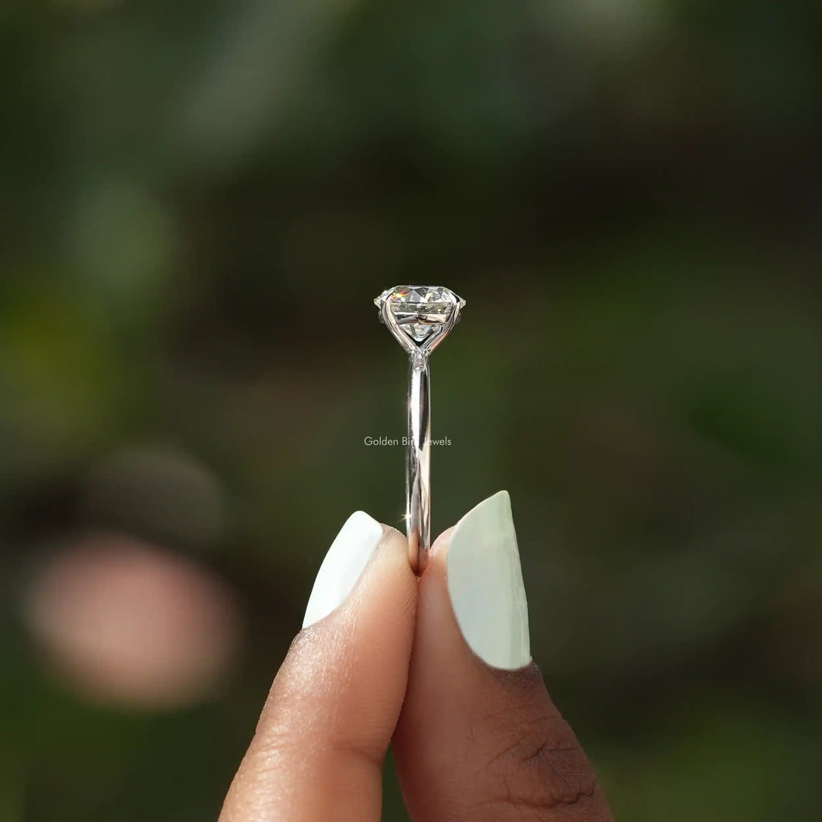 Side View of Old European Round Cut Solitaire Ring In two fingers