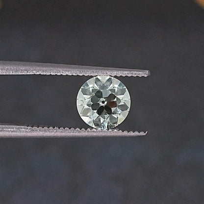 Old European round loose lab diamond between silver tweezers, face-on view