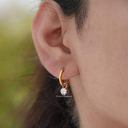 Gold-tone hoop dangle earrings with round moissanite centerpiece