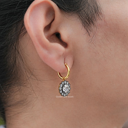 Gold hoop dangle earring with round halo of clear stones, shown from the side