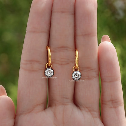 Pair of gold-tone dangle earrings with round moissanite stones