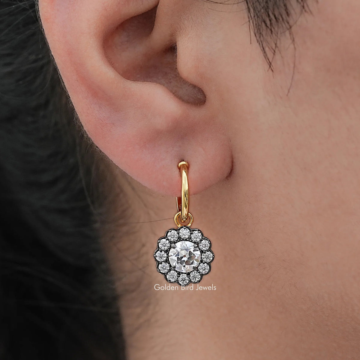 Gold hoop dangle earring with round halo clear-stone centerpiece and scalloped border