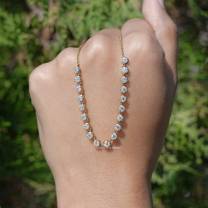 Gold-tone moissanite tennis necklace featuring round-cut stones in a curved row