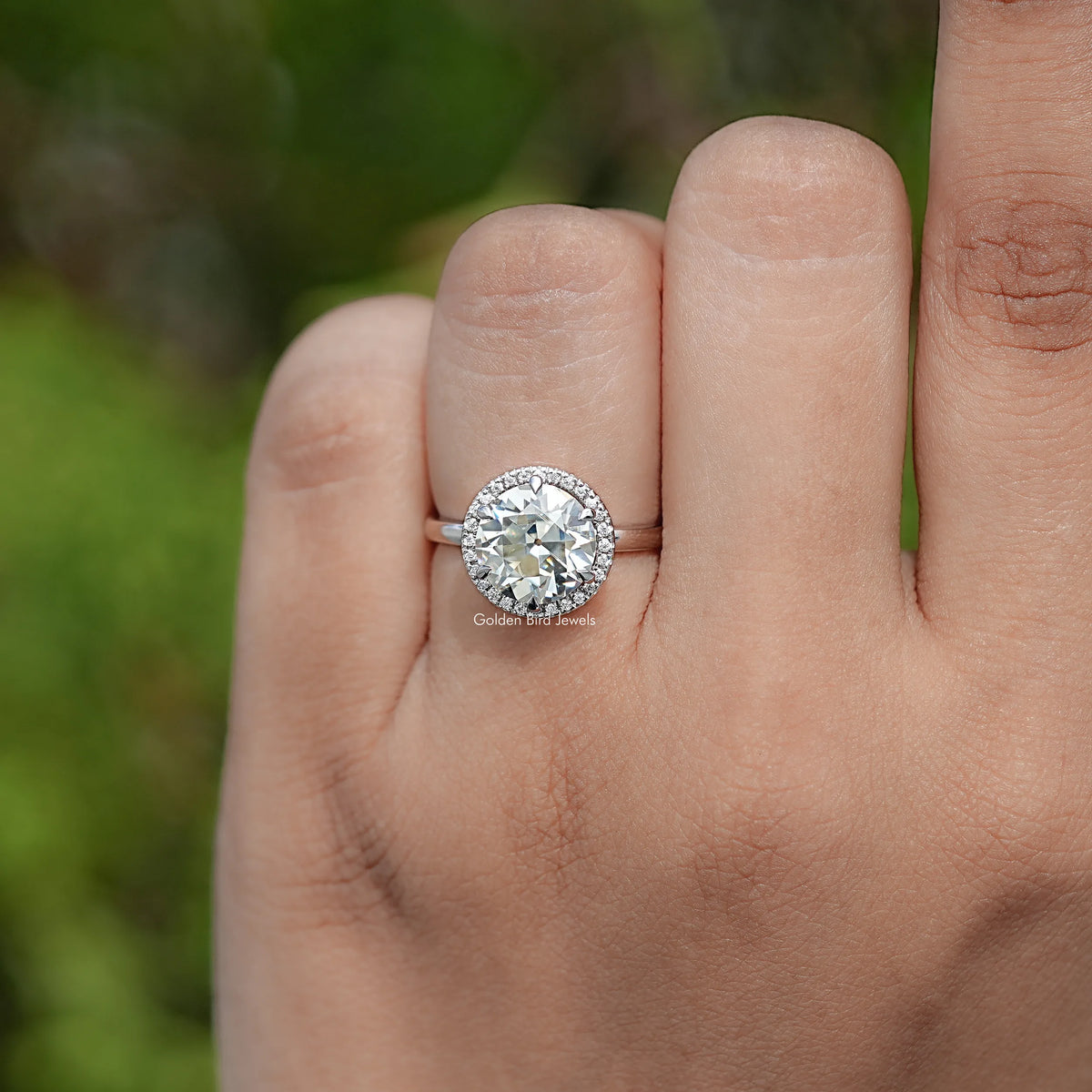 In finger view of Round Cut Moissanite Engagement Ring