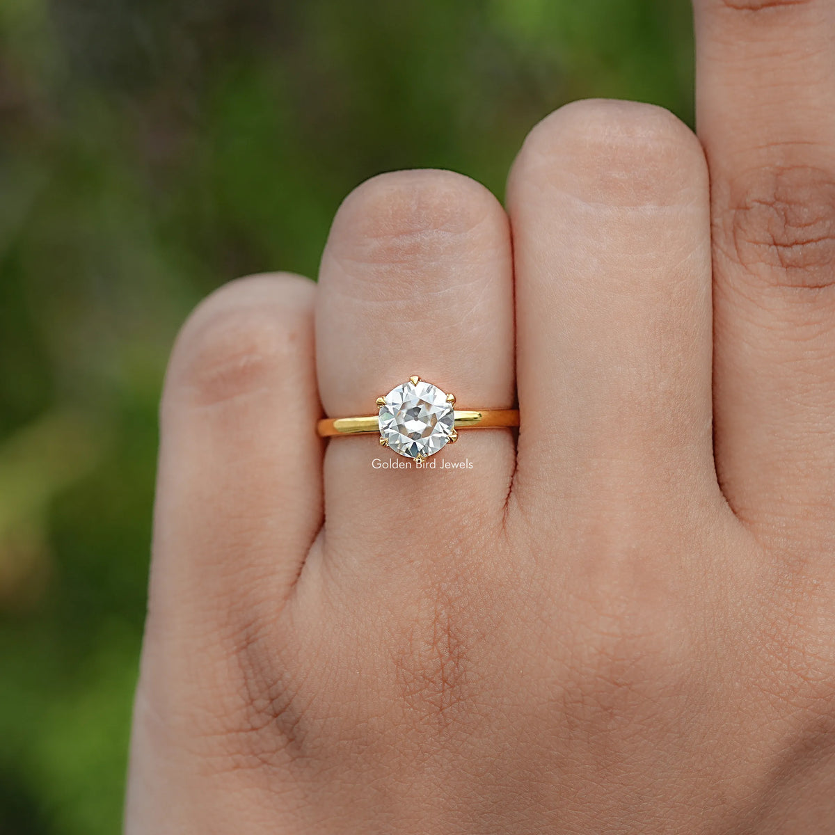In finger view of Round Cut Moissanite Engagement Ring