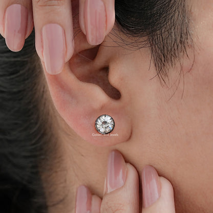 Round moissanite stud earrings on ear, single earring visible