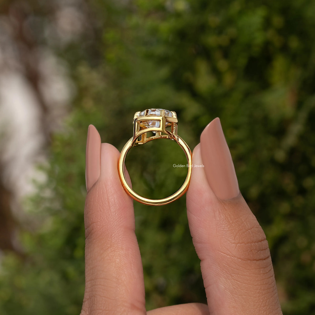 Top view of gold-tone solitaire ring with pear-cut center stone