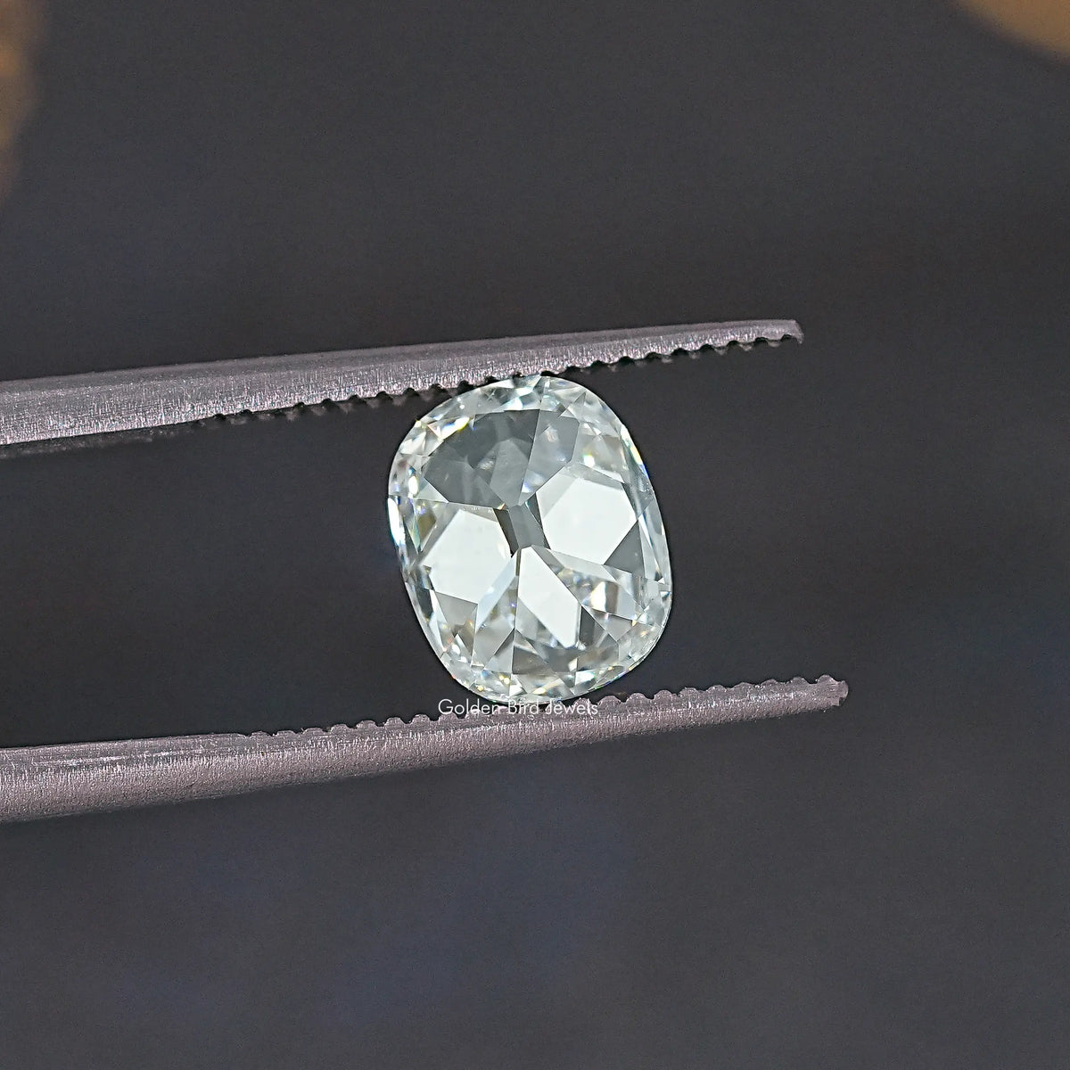 Old Mine cut lab-grown diamond close-up, oval cushion with high-contrast facets.