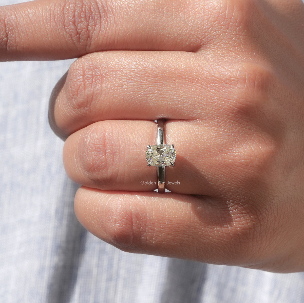 Cushion-cut moissanite solitaire ring with slim band and four-prong setting