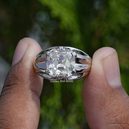 Cushion-cut solitaire moissanite ring with faceted halo-style prongs, close-up