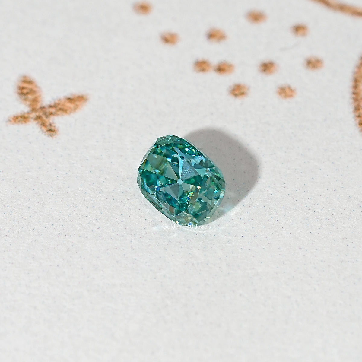 Blue-green cushion-cut moissanite gemstone, single loose stone with faceted sparkle.