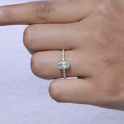 Moissanite ring with elongated cushion-cut center stone and pavé band on a hand