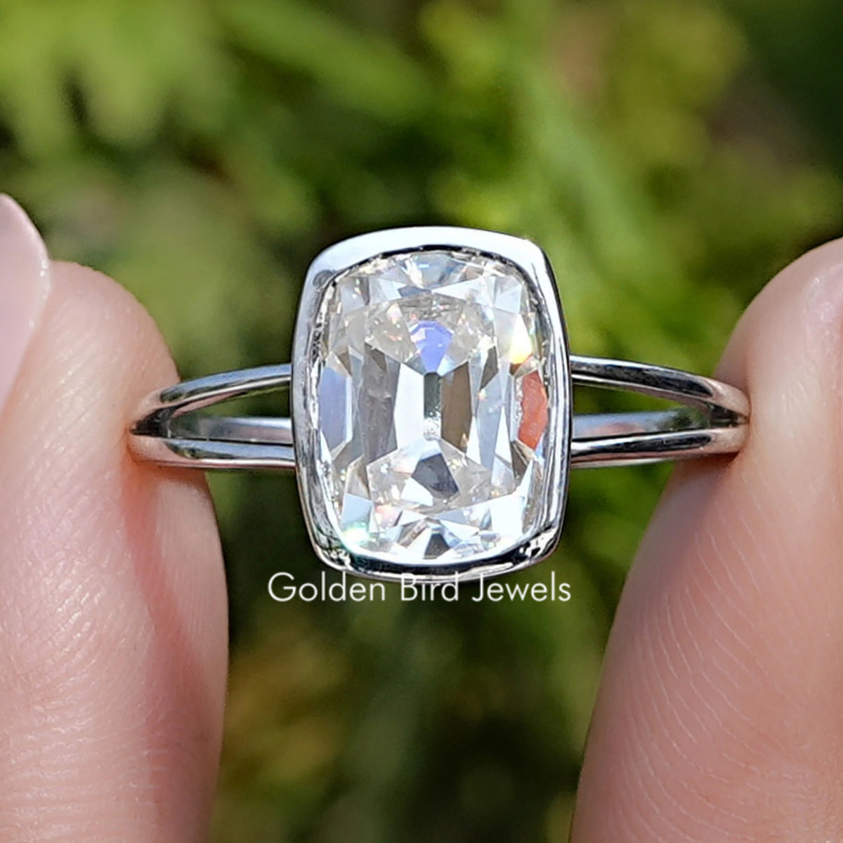 Front view of Old Mine Cushion Cut Moissanite Split Shank Ring in two fingers 