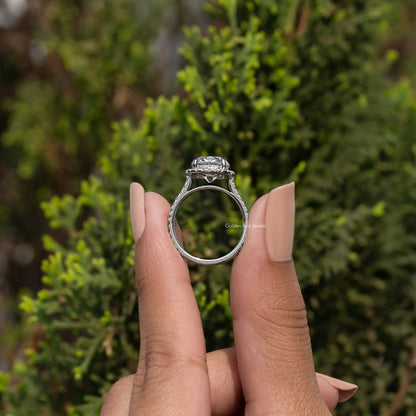 Back view of halo cushion-cut moissanite ring on fingers, prongs and band visible