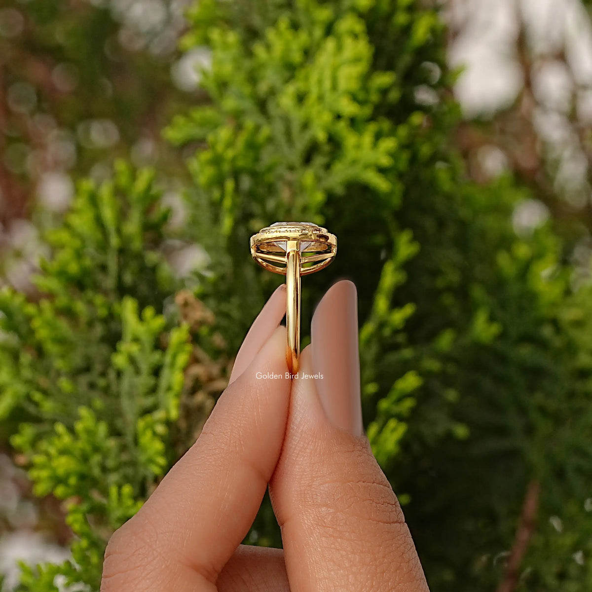 Gold-tone ring underside view showing prongs and open gallery under center stone