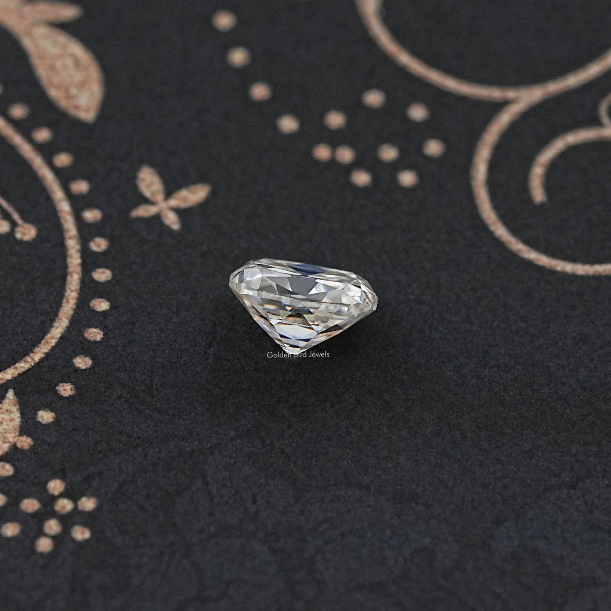 Loose cushion-cut moissanite gemstone, white prismatic facets on dark surface