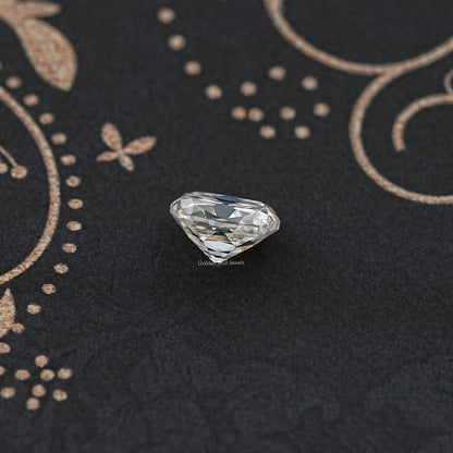 Loose cushion-cut moissanite gemstone, white prismatic facets on dark surface