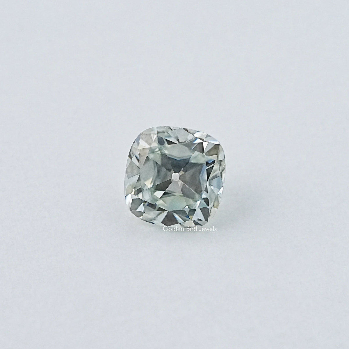 Cushion-cut moissanite gemstone, pale blue, centered face-up view