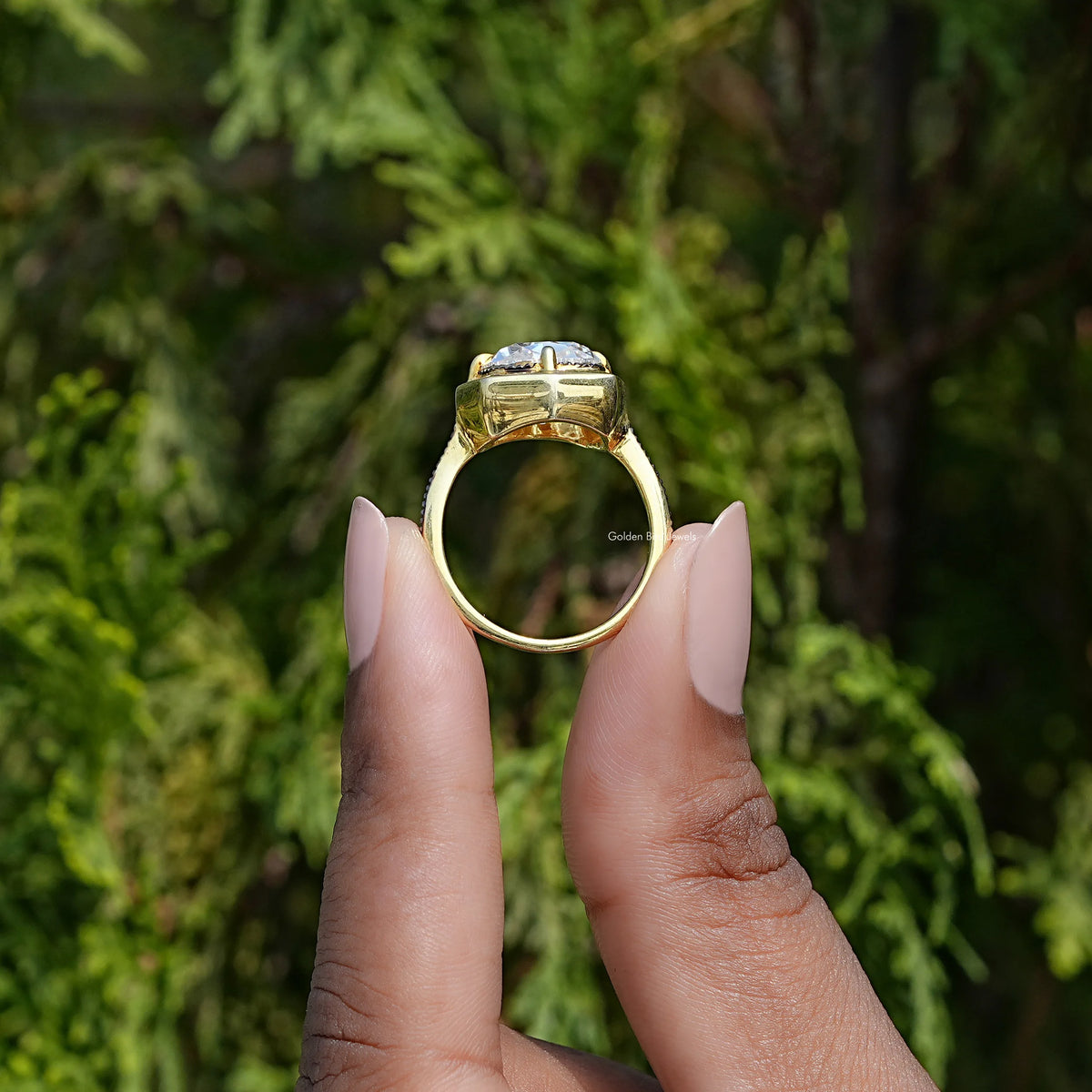 Gold-tone milgrain cushion moissanite engagement ring, side view showing prongs and band