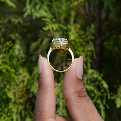 Gold-tone milgrain cushion moissanite engagement ring, side view showing prongs and band