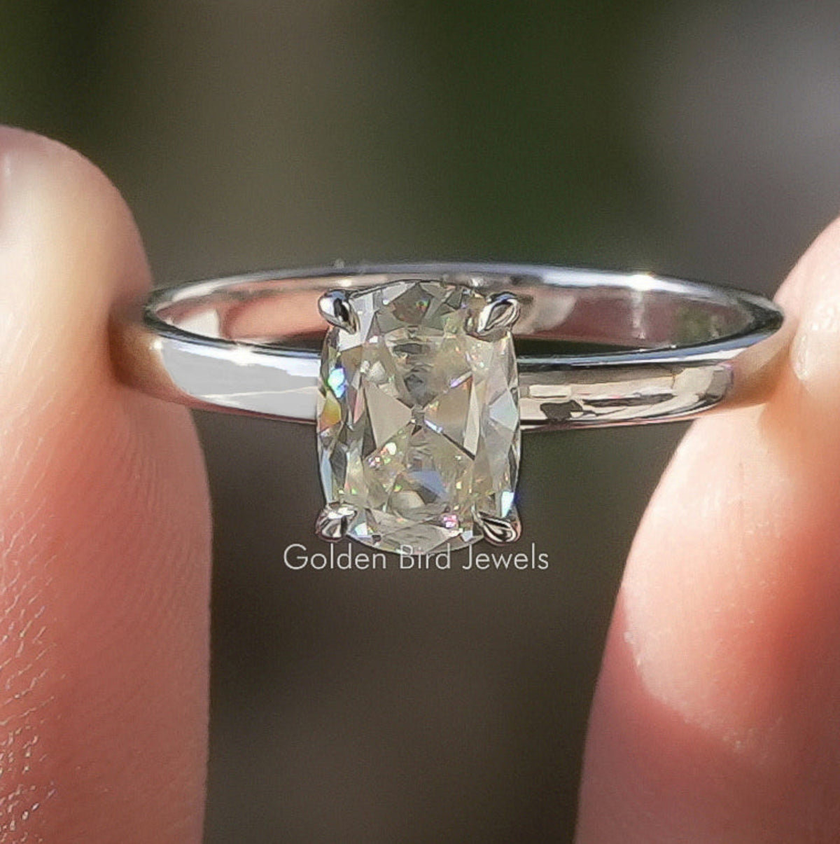Silver solitaire ring with cushion-cut moissanite center stone and prong setting