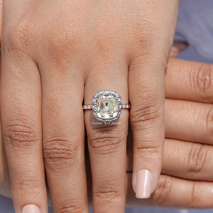 Silver cushion-cut moissanite ring close-up on hand, halo setting on band