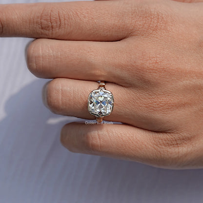Gold cushion-cut moissanite solitaire ring, side view on hand