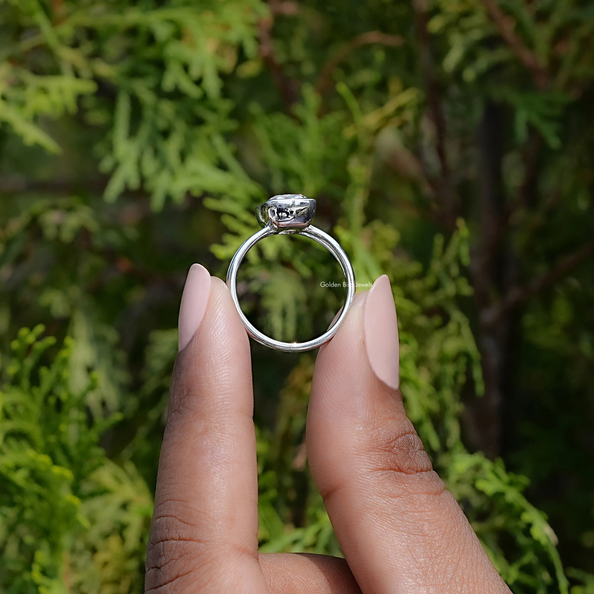 In hand showing view of moissanite Ring	 		
