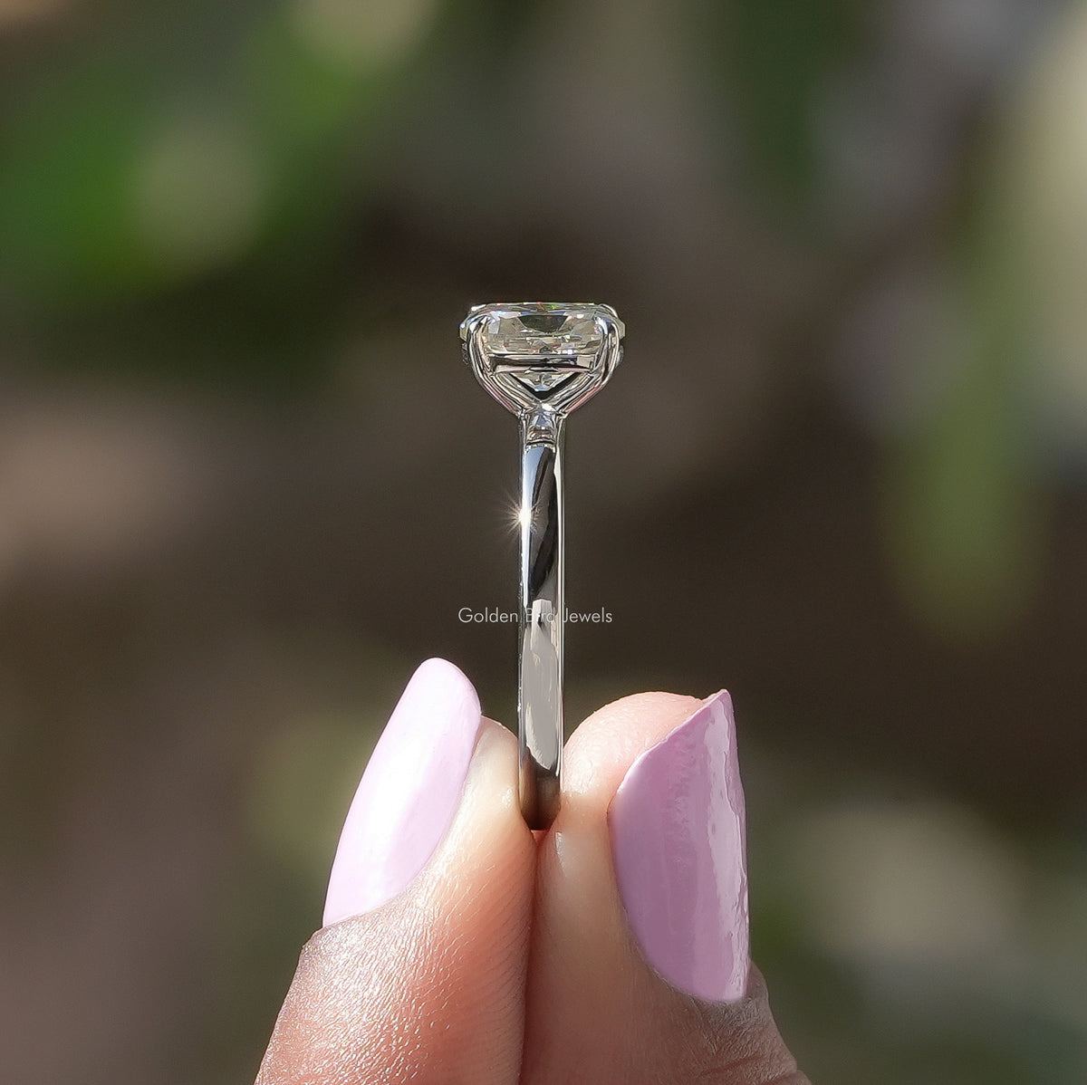 Close-up of cushion-cut moissanite solitaire ring prongs and center stone