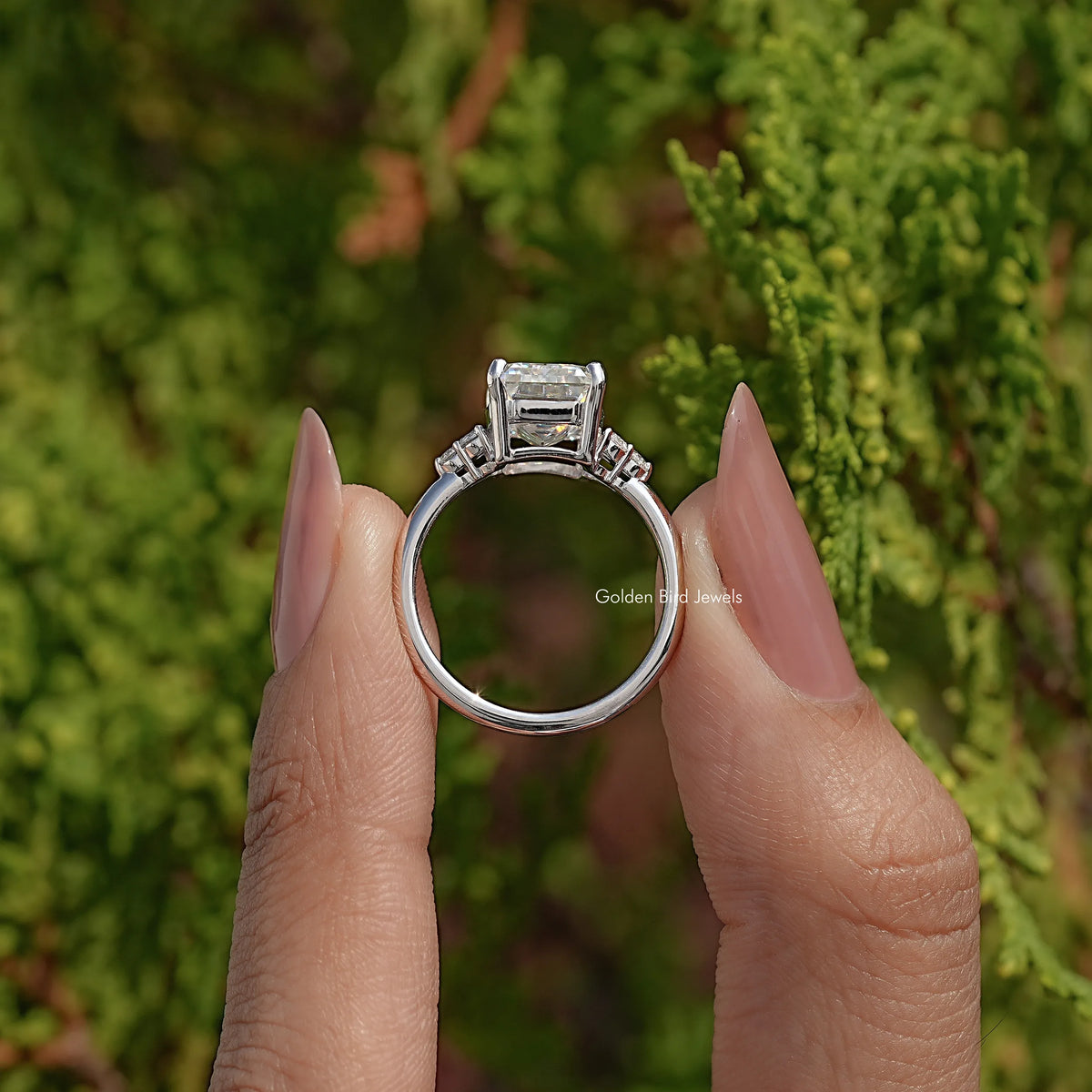 Back view of emerald-cut moissanite ring showing open gallery under center