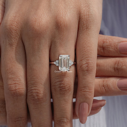 Emerald-cut moissanite engagement ring with baguette side stones, silver band
