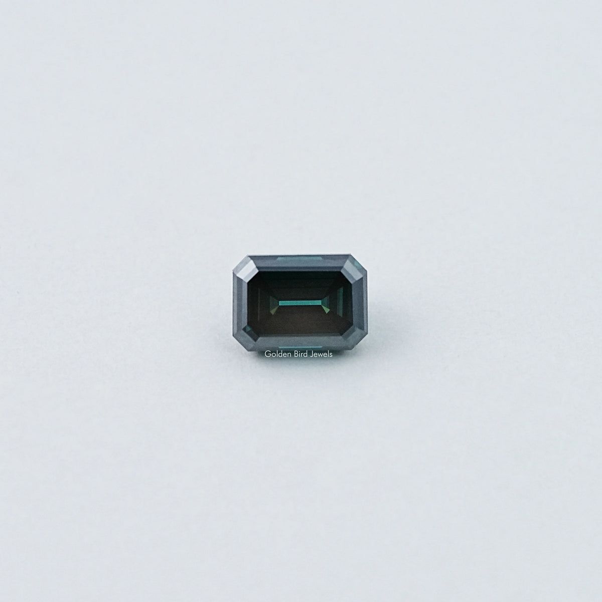 Loose emerald-cut dark green moissanite gemstone, front view with dark center