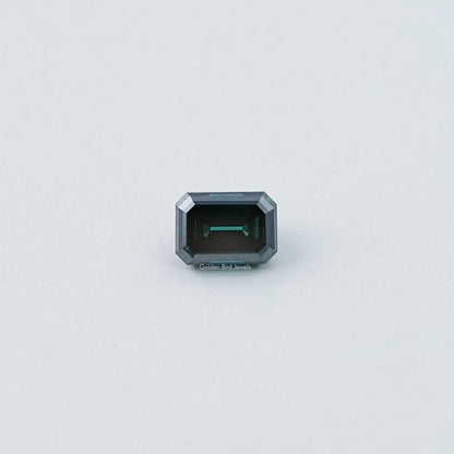 Loose emerald-cut dark green moissanite gemstone, front view with dark center