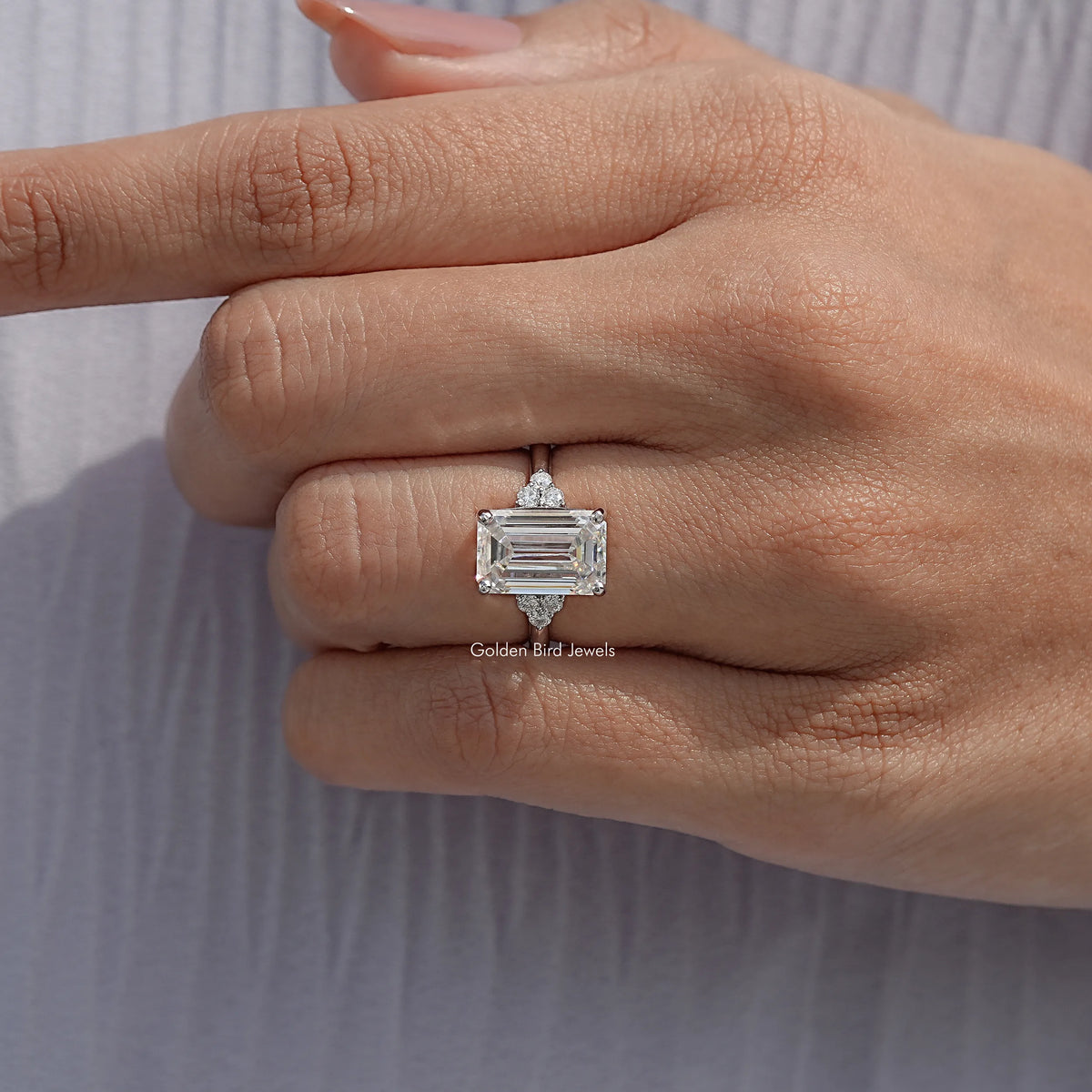 Emerald-cut moissanite ring with low-profile setting and split shoulders