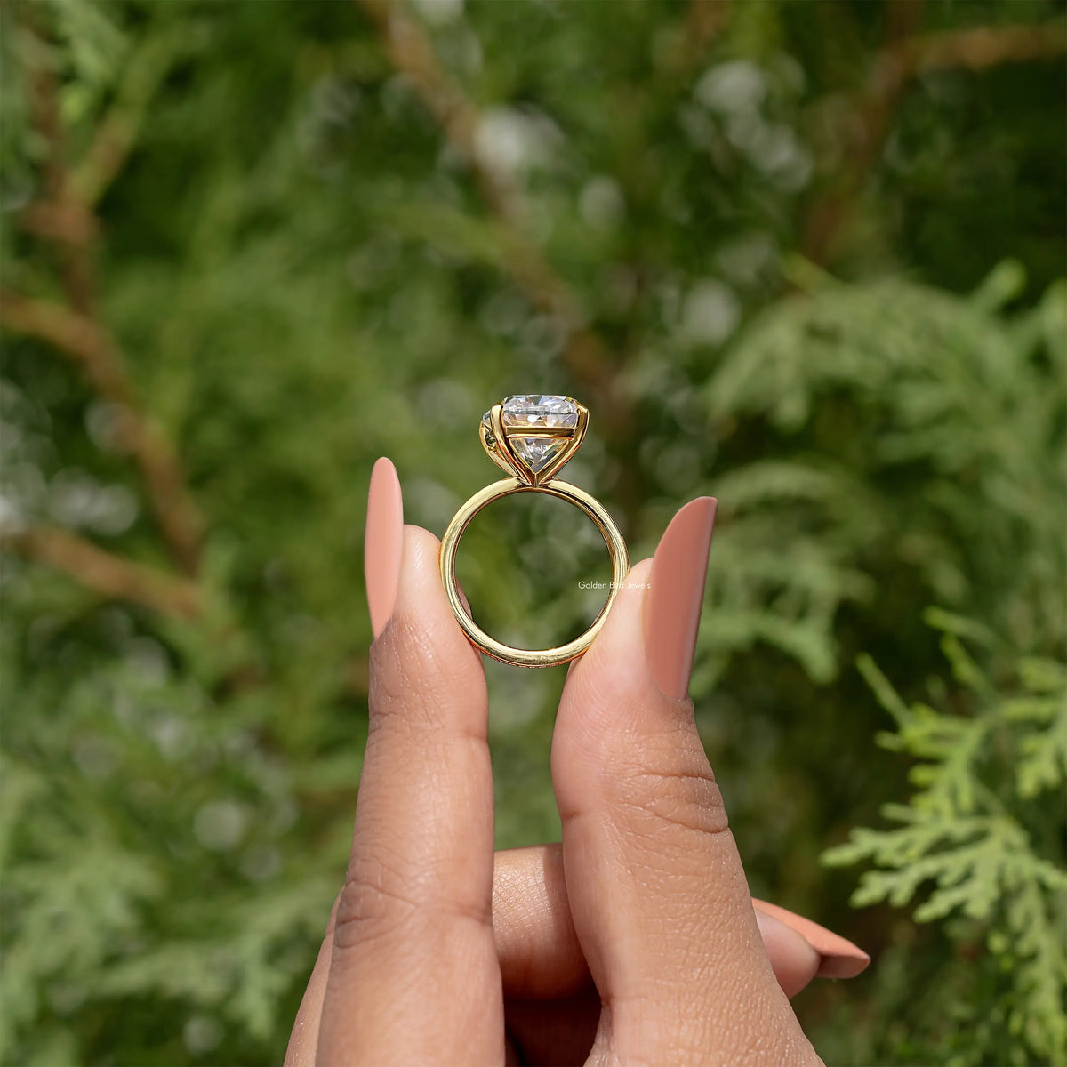 Gold engagement ring with cushion-cut clear center stone and petite side accents