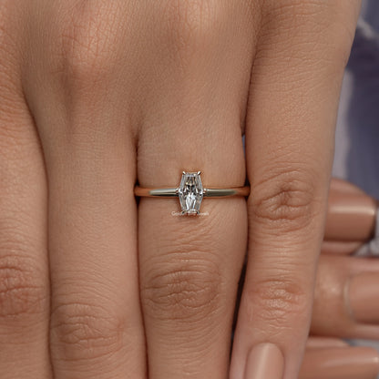 Gold-tone solitaire ring with baguette-cut moissanite center stone and prong setting