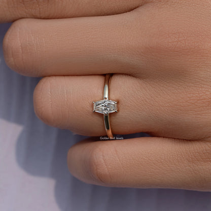Gold-tone solitaire ring with baguette-cut moissanite center stone, side view