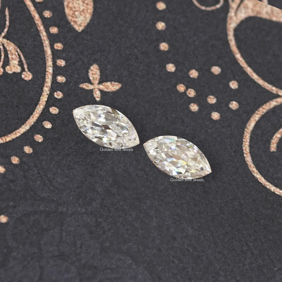 Two marquise-cut moissanite stones with faceted sparkle