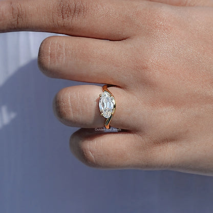 Gold-tone solitaire moissanite ring with oval center stone and four-prong head