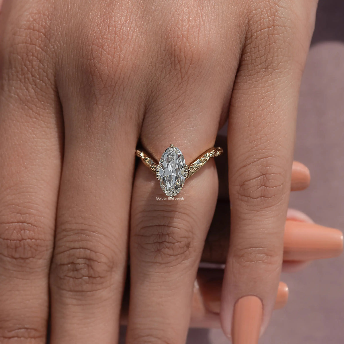 Curved diamond ring with large oval center stone on hand, close-up