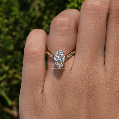 Curved diamond ring with large center stone and gold-tone setting on hand