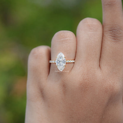 Moissanite engagement ring on hand, featuring an oval center stone and side accents