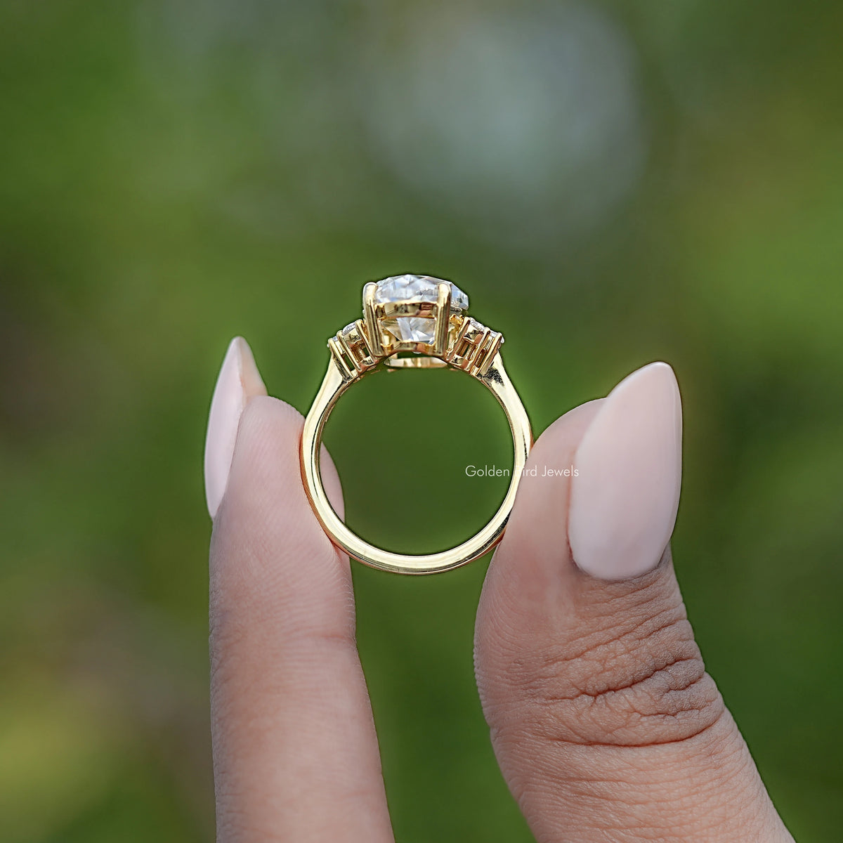 Gold ring with oval center moissanite and accent stones
