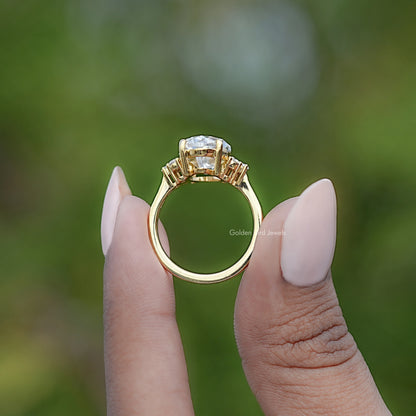 Gold ring with oval center moissanite and accent stones