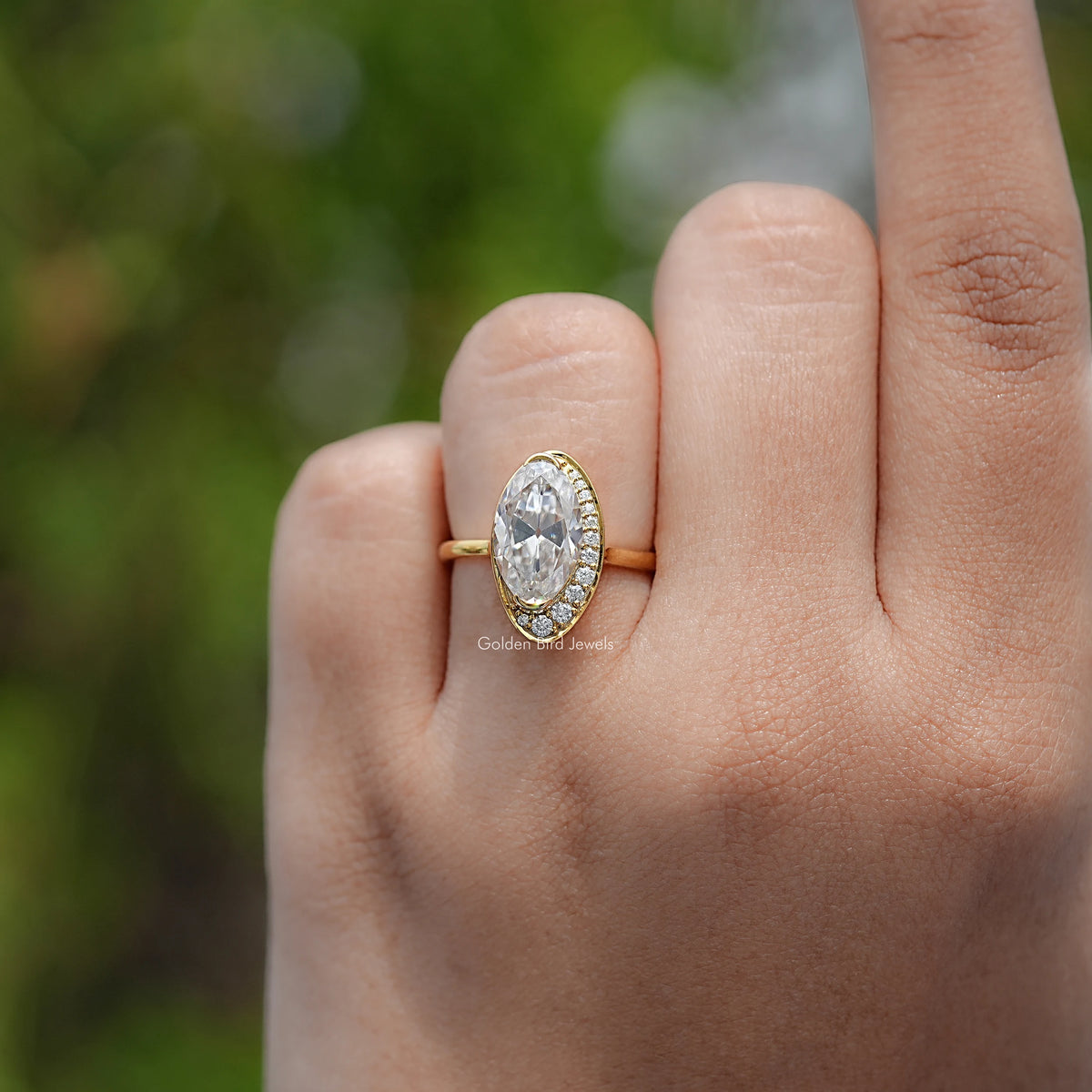 Gold oval-cut moissanite ring with slim band and small side sparkle stones